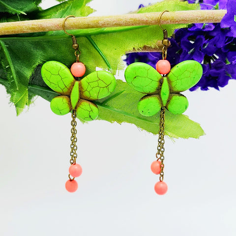 Handmade g butterfly dangle earrings with red bead accents and antique brass chain drops – boho insect-inspired jewelry for women