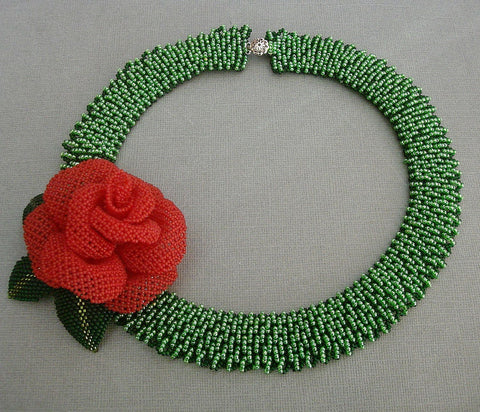 Handmade green beaded necklace with a red rose centerpiece and leaf accents, featuring intricate beadwork, perfect for weddings, parties, and special occasions.