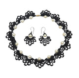 Handmade black beaded necklace and earrings set with white pearls in an elegant lace-inspired fan design, perfect for special occasions or as a unique gift.