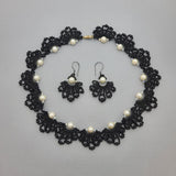 Handmade black beaded necklace and earrings set with white pearls in an elegant lace-inspired fan design, perfect for special occasions or as a unique gift.