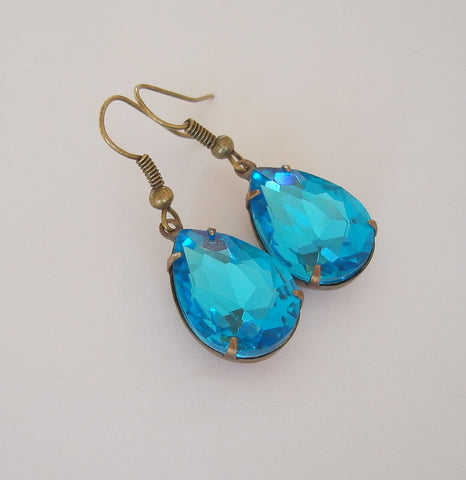 Aqua Swarovski Teardrop In Antiqued Brass Prong Settings.