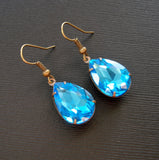 Aqua Swarovski Teardrop In Antiqued Brass Prong Settings.
