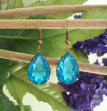 Aqua Swarovski Teardrop In Antiqued Brass Prong Settings.