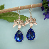 Silver Orchid And Sapphire Faceted Teardrop Crystal Earrings.