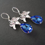 Silver Orchid And Sapphire Faceted Teardrop Crystal Earrings.