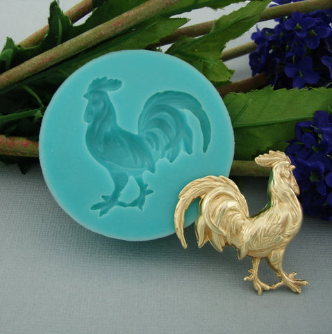 The mold features intricate feather details and a raised design for creating 3D rooster-shaped cakes, chocolates, or soaps