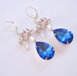 Silver Orchid And Sapphire Faceted Teardrop Crystal Earrings.
