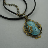 Turquoise Lucite Oval Cabochon Filigree Wrapped Suede Cord Necklace.