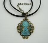 Turquoise Lucite Oval Cabochon Filigree Wrapped Suede Cord Necklace.